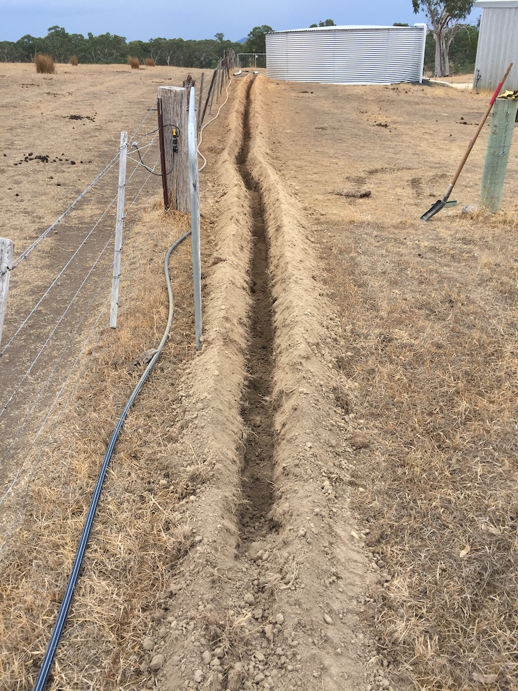 Long trench in hard dry ground for putting pipe in