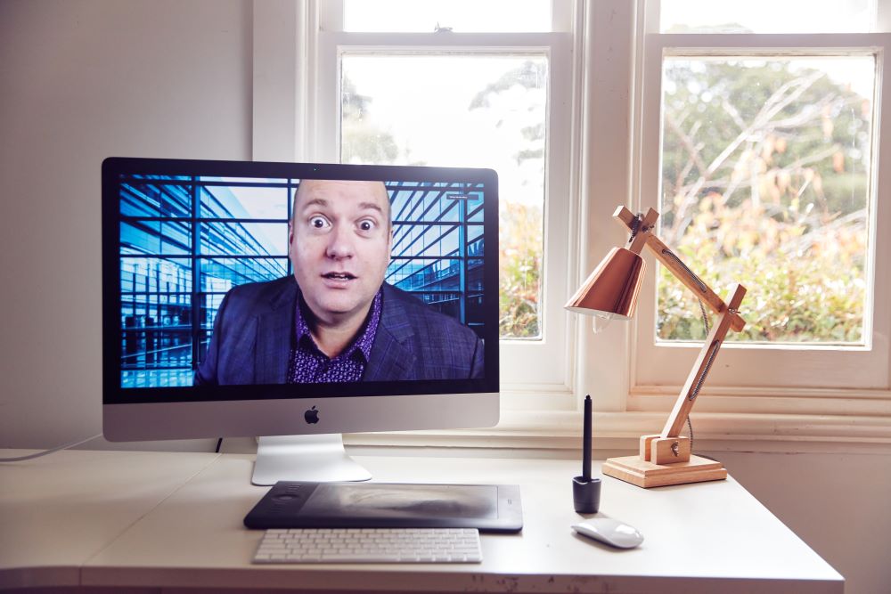 Warwick Merry on a screen at  a desk with an incredibly surprised look on his face